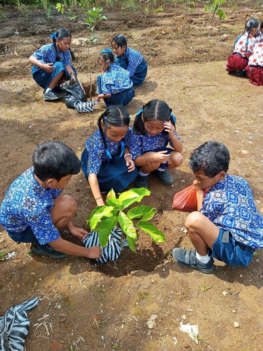 Children planting a tree together