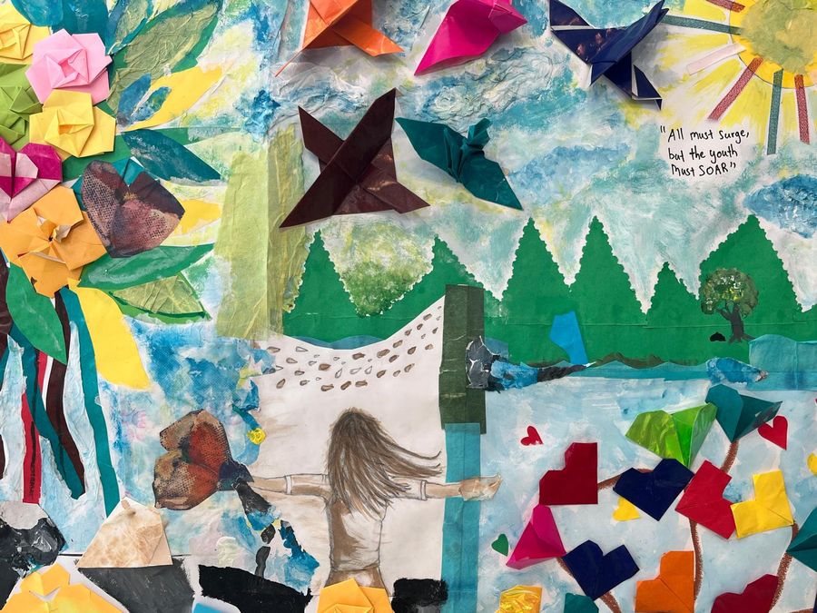 Mixed-media collage artwork of a child with arms outstretched before a mountain landscape